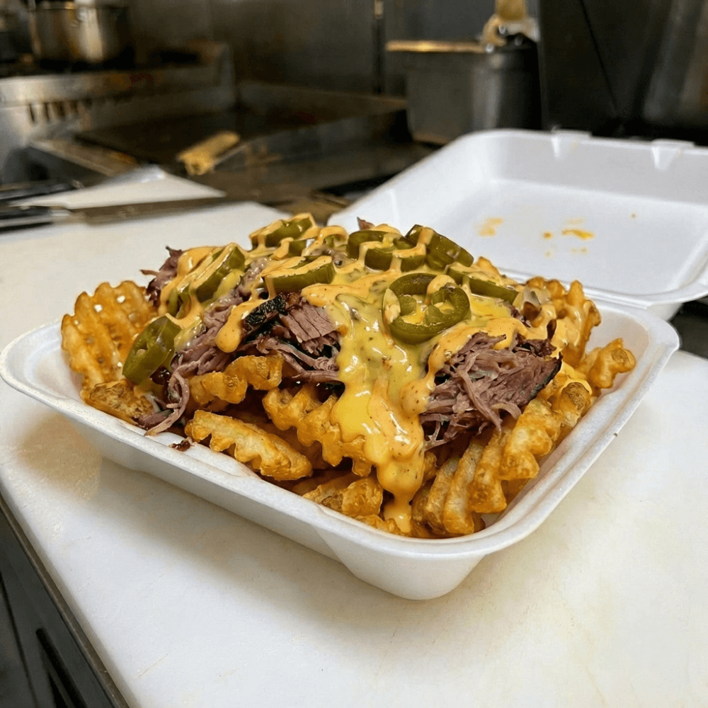 Waffle fries topped with brisket, queso, jalapenos and chipotle mayo